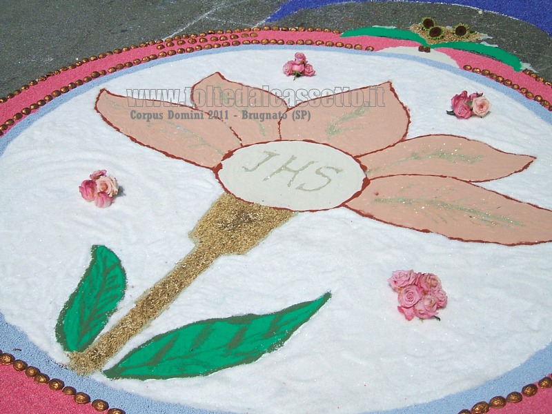 BRUGNATO (Infiorata del Corpus Domini 2011) - Disegno di un petalo di fiore contornato da rose, realizzato principalmente con sale e sabbia colorata